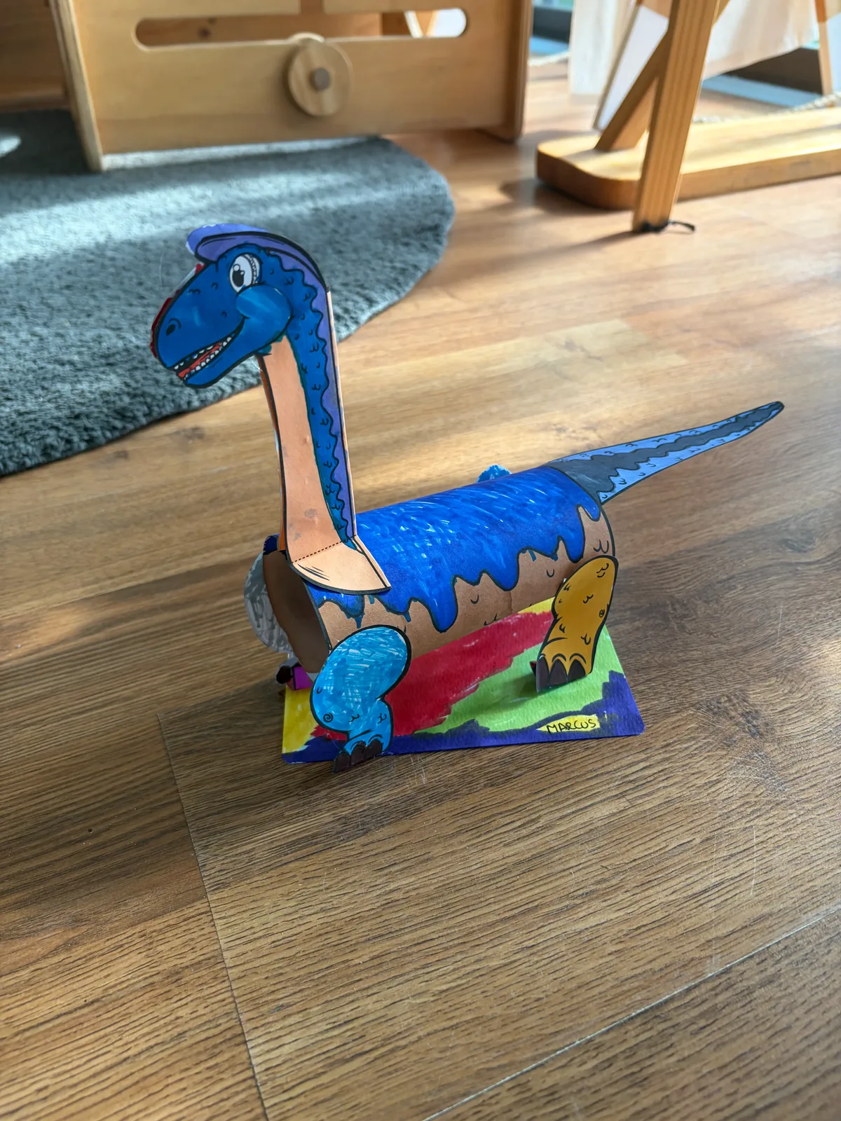 A finished dinosaur craft project made by a child at a Bluey's Imaginations workshop