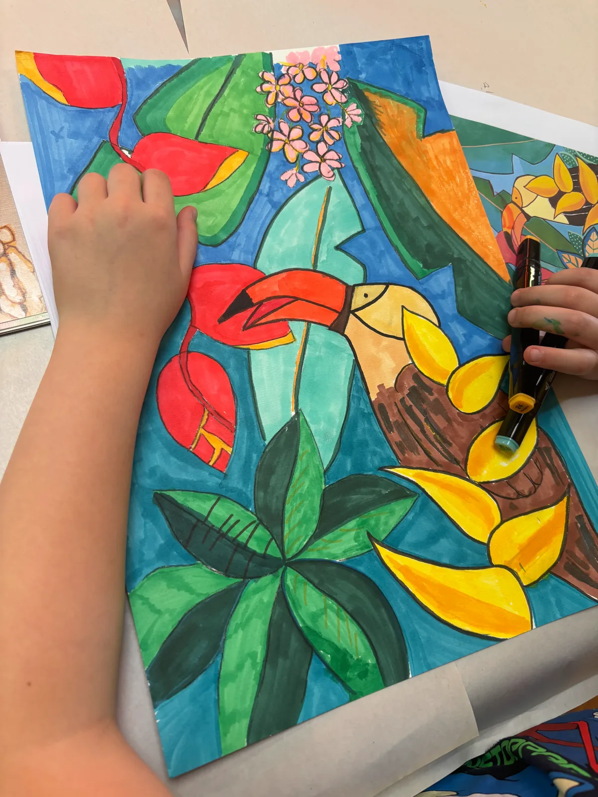 A child's mixed-media artwork combining paint and craft materials from a creative workshop